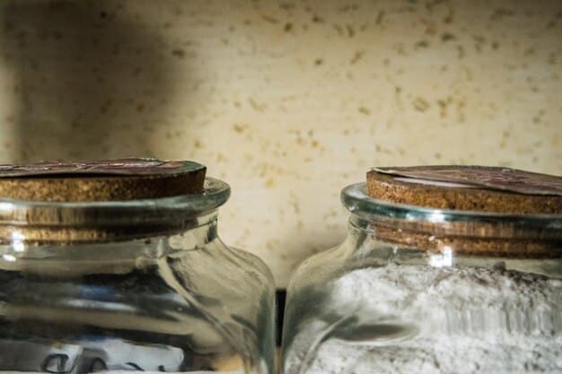 Close up image of old mason jars being used to store dry goods such as pasta, granola and coffee beans.