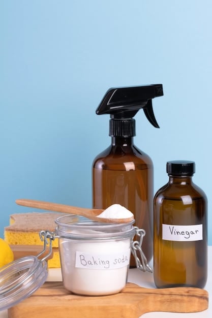 A set of neatly arranged homemade cleaning supplies, including spray bottles filled with vinegar-based solutions, a jar of baking soda paste, and a bowl of lemon halves. The background is a clean and organized pantry shelf.
