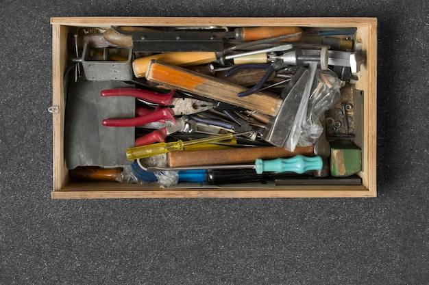 A close-up shot of a well-organized toolbox, showcasing various hand tools such as screwdrivers, pliers, wrench, hammer, and measuring tape.