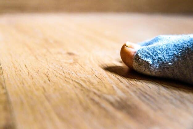 A close-up shot of someone carefully sanding a wooden table leg, highlighting the texture of the wood and the fine dust particles being removed.