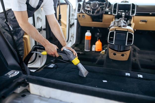 A person cleaning the interior of a car, focusing on vacuuming the carpets and detailing the dashboard with appropriate cleaning products.