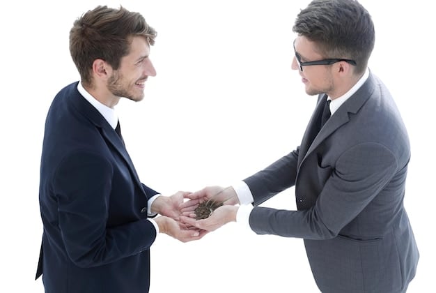 A handshake between a person and a credit counselor, symbolizing trust and partnership in achieving financial stability. The background features a clean and organized office setting, reinforcing the professional nature of the consultation.