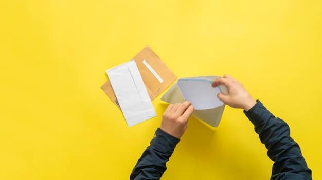 A person placing a check into an envelope.