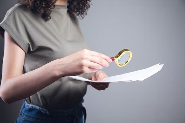 A close-up of a person's hands holding a magnifying glass over a document filled with fine print, symbolizing the importance of scrutinizing details and terms.