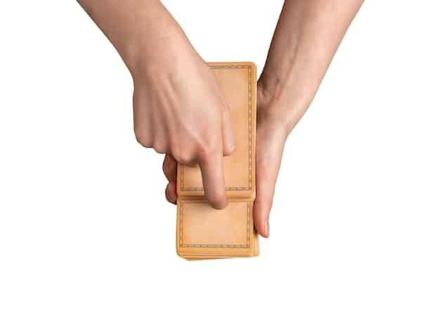 Close-up shot of hands placing cash into an envelope labeled 