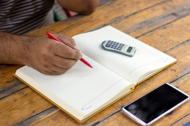 A person using a financial calculator to determine mortgage affordability, with a pen and notebook nearby.