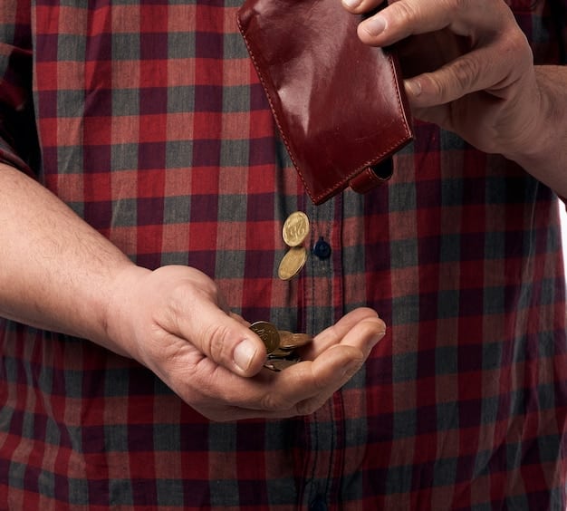 A detailed shot of various bills and coins, with a hand placing a coin into a transparent piggy bank labeled 